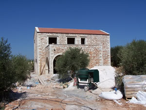 Two floor stone home with extensive terrace and patio areas